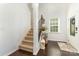 Bright entryway featuring hardwood floors, staircase and a decorative console table, with easy access at 1037 Delridge St, Waxhaw, NC 28173