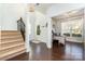 Bright entryway featuring hardwood floors, staircase, and adjacent office or study space at 1037 Delridge St, Waxhaw, NC 28173
