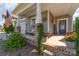 Inviting covered front porch with stone pillars, cozy seating, and a 'Welcome' sign at 1037 Delridge St, Waxhaw, NC 28173