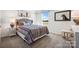 Comfortable bedroom with patterned bedspread, bright natural light, and simple furniture at 1048 Arundle Rd, Sherrills Ford, NC 28673