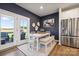 Inviting dining area with a modern table, stainless steel refrigerator, and patio access at 1048 Arundle Rd, Sherrills Ford, NC 28673
