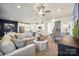 Open-concept living room with a view to the kitchen, and a staircase leading upstairs at 1048 Arundle Rd, Sherrills Ford, NC 28673
