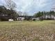 Rustic home with a large yard, sheds, and surrounding trees, creating a peaceful setting at 10516 Hambright Rd, Huntersville, NC 28078