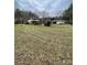 Exterior view of home, shed, and outbuildings on a large lot with mature trees at 10516 Hambright Rd, Huntersville, NC 28078