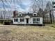 Charming one-story home featuring dormer windows and a red brick chimney at 10516 Hambright Rd, Huntersville, NC 28078