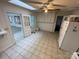 Well-lit kitchen with tile floors and access to a sunroom at 10516 Hambright Rd, Huntersville, NC 28078