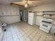 Functional kitchen with tile floors and white appliances at 10516 Hambright Rd, Huntersville, NC 28078