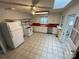 Bright kitchen with white appliances and a red countertop at 10516 Hambright Rd, Huntersville, NC 28078