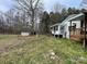 Backyard view showcases the house, an outbuilding, and a lot of trees at 10516 Hambright Rd, Huntersville, NC 28078