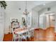 Charming dining area featuring hardwood floors, a chandelier, and lots of natural light at 11003 Pale Hickory Ln, Charlotte, NC 28215