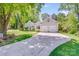 Attractive home with a well-kept lawn, mature trees, and a two-car garage at 11003 Pale Hickory Ln, Charlotte, NC 28215