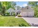Charming home with a well-manicured lawn, lush landscaping, and a two-car garage at 11003 Pale Hickory Ln, Charlotte, NC 28215