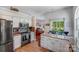Bright kitchen features white cabinets, granite countertops, and stainless steel appliances at 11003 Pale Hickory Ln, Charlotte, NC 28215