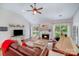 Cozy living room showcases wood floors, a fireplace, and plenty of natural light from the large windows at 11003 Pale Hickory Ln, Charlotte, NC 28215