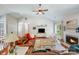 Bright living room boasts a vaulted ceiling, wood floors, a cozy fireplace, and a large window at 11003 Pale Hickory Ln, Charlotte, NC 28215