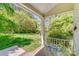 Relaxing screened porch with a glass top table overlooking a lush green yard at 11003 Pale Hickory Ln, Charlotte, NC 28215