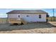 Backyard of a gray home featuring a wooden deck, back door, and manicured landscaping at 1235 E Poplar St, Conover, NC 28613