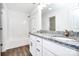 Bathroom with dual vanity, granite countertop, and shower-tub combo at 1235 E Poplar St, Conover, NC 28613