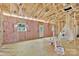Unfinished room with insulation and exposed wood framing, window, and door at 1235 E Poplar St, Conover, NC 28613