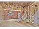 Unfinished room with insulation and exposed wood framing with a door and window at 1235 E Poplar St, Conover, NC 28613