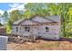 Exterior view of a house with trees in the background and construction supplies in the yard at 1235 E Poplar St, Conover, NC 28613