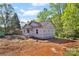 New home construction featuring a covered porch and foundation on a spacious lot surrounded by lush trees at 1235 E Poplar St, Conover, NC 28613