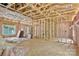 Exposed framing and pink insulation showcase the interior of a home under construction with natural light at 1235 E Poplar St, Conover, NC 28613