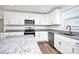 Well-lit kitchen with granite countertops, stainless appliances, and white cabinetry at 1235 E Poplar St, Conover, NC 28613