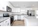 Bright kitchen with stainless steel appliances, white cabinets, and granite countertops at 1235 E Poplar St, Conover, NC 28613