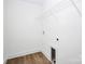 Clean, all-white laundry room with shelving and luxury vinyl plank flooring at 1235 E Poplar St, Conover, NC 28613