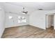 Bright, neutral living room with sleek flooring, a ceiling fan, and large windows for natural light at 1235 E Poplar St, Conover, NC 28613