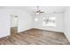Bright, neutral living room featuring sleek flooring, a ceiling fan, and large windows for natural light at 1235 E Poplar St, Conover, NC 28613