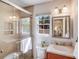 Bathroom with shower, large mirror, and cherry-stained vanity offers practical elegance at 1327 Cedarwood Ln, Charlotte, NC 28212