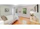 Bright bedroom with hardwood floors, neutral walls, and bright windows overlooking the lush landscape at 1327 Cedarwood Ln, Charlotte, NC 28212