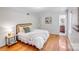 Bright bedroom with wood floors, neutral decor, and an en-suite bathroom at 1327 Cedarwood Ln, Charlotte, NC 28212