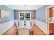Elegant dining room featuring blue wallpaper, hardwood floors, and stylish lighting at 1327 Cedarwood Ln, Charlotte, NC 28212
