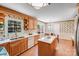 Well-maintained kitchen with wooden cabinetry, white countertops, and an eat-in area at 1327 Cedarwood Ln, Charlotte, NC 28212
