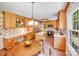Bright kitchen features wood cabinets, a kitchen island with white countertop and a chandelier above the breakfast table at 1327 Cedarwood Ln, Charlotte, NC 28212