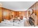 Cozy living room features wood paneled walls, a fireplace and comfortable seating at 1327 Cedarwood Ln, Charlotte, NC 28212