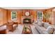 Welcoming living room features wood paneling, fireplace, and comfortable seating, creating a warm ambiance at 1327 Cedarwood Ln, Charlotte, NC 28212