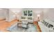 Inviting living room with hardwood floors, bright windows and comfortable white sofas at 1327 Cedarwood Ln, Charlotte, NC 28212