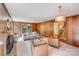 Inviting living room showcasing wood paneled walls, fireplace, and natural lighting at 1327 Cedarwood Ln, Charlotte, NC 28212