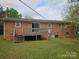 Expansive brick home featuring a wooden deck overlooking a spacious backyard at 13316 E Rocky River Rd, Davidson, NC 28036