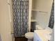 Compact full bathroom with a shower-tub combo and patterned shower curtain at 13316 E Rocky River Rd, Davidson, NC 28036