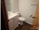 Clean half bath featuring a modern sink, toilet, and updated fixtures at 13316 E Rocky River Rd, Davidson, NC 28036