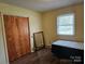Bright bedroom with a closet, window, and simple finishes at 13316 E Rocky River Rd, Davidson, NC 28036