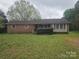 Charming single-story brick home with a well-maintained yard and inviting covered front porch at 13316 E Rocky River Rd, Davidson, NC 28036