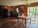 Open kitchen layout with wood cabinets, black appliances, and adjacent dining area with backyard access at 13316 E Rocky River Rd, Davidson, NC 28036