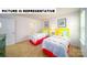 This vibrant bedroom features carpeted flooring, two yellow twin beds, and decor for a fun, playful atmosphere at 134 Woodhall Way, Troutman, NC 28166