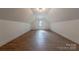 Spacious, naturally lit attic featuring wood flooring and a modern light fixture at 13625 Buster Rd, Stanfield, NC 28163